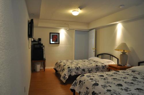 a hotel room with two beds and a television at K7 Bed and Breakfast in Pahrump