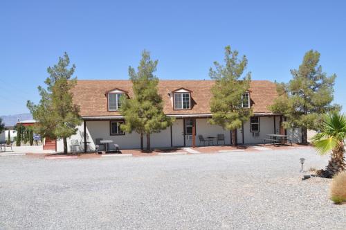 a house with trees in front of it at K7 Bed and Breakfast in Pahrump