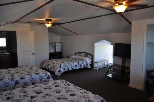 a hotel room with two beds and a television at K7 Bed and Breakfast in Pahrump
