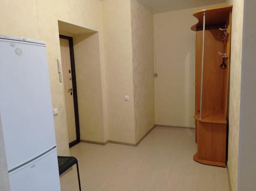 um quarto vazio com um frigorífico e um armário em 1к. Апартаменты НСК , на пр.Карла Маркса 11 em Novosibirsk