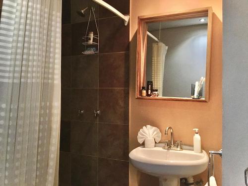 a bathroom with a sink and a shower with a mirror at My Lovely Loft Beach RG3 in Puerto Vallarta