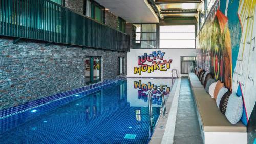 a swimming pool with graffiti on the side of a building at Lucky Monkey Hotel in Antalya