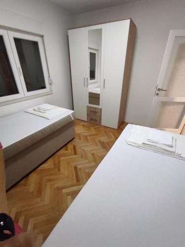 a small room with a bed and a mirror at Apartman Olga in Trebinje