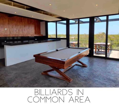 a pool table in a room with the words billlords in common area at Casa Kuaan Mani TH 1 in Tulum