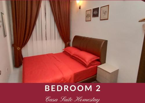 a bedroom with a bed with red sheets and a window at Casa Suite Homestay D'Imperio Professional Suite in Alor Setar