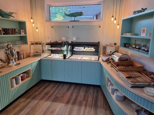 una cocina con armarios verdes y una barra con comida en Hotel Restaurant Bootshaus, en Achim