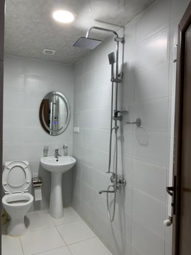 a bathroom with a shower and a toilet and a sink at Hotel Red Bridge in Kutaisi