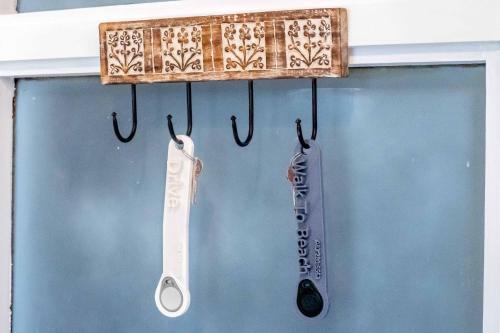 a pair of toothbrushes are hanging in a window at Walk To Beach 704 Umdloti Holiday Resort in Umdloti