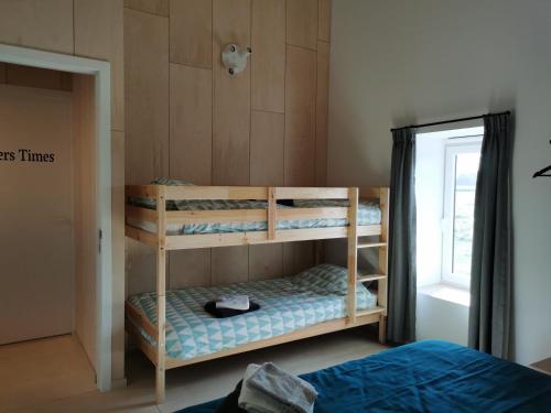 a bedroom with two bunk beds and a window at Sint-Sixtus 99 in Poperinge
