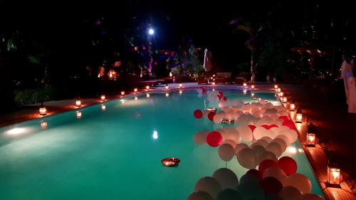 a swimming pool with umbrellas in the water at night at Ksar Salha in Marrakech