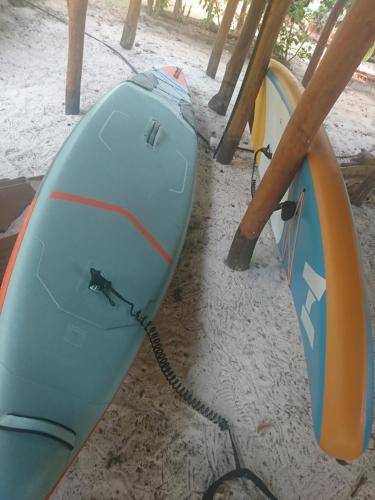 two surfboards are sitting on the sand next to at COCO REEF ECOLODGE in Kizimkazi