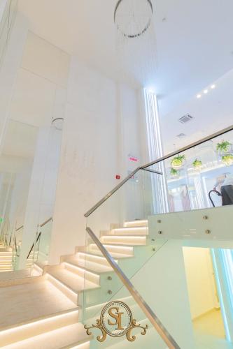 a staircase in a building with a glass railing at Pensiunea Iristar in Fălticeni