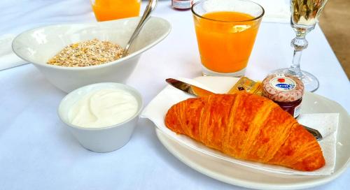 a table with a plate of bread and a bowl of milk at L'Host Boutique Rooms in Pollença