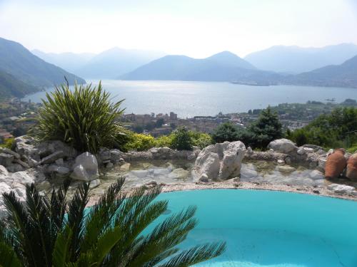 a swimming pool with a view of a lake at Villa Romele in Pisogne
