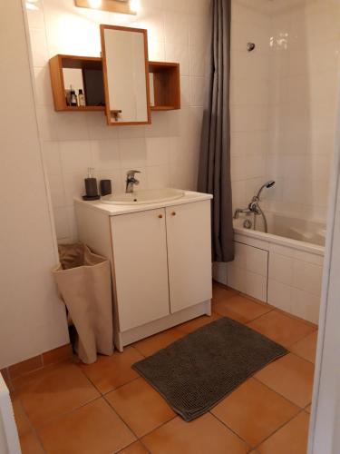une salle de bain avec un lavabo et une baignoire dans l'établissement T3 duplex lumineux en centre-ville (plage à 10mn), à Soustons