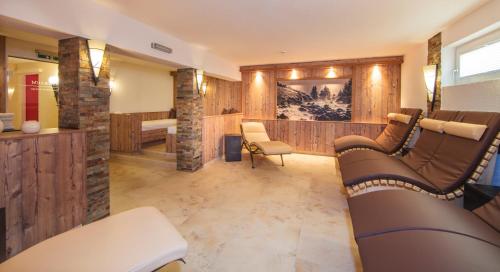 a living room with a couch and a table at Panorama Appartements in Längenfeld