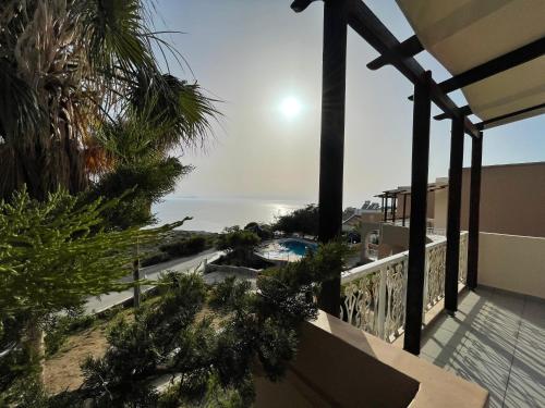 a view of the ocean from the balcony of a house at Nostalgia Villas in Tersanas