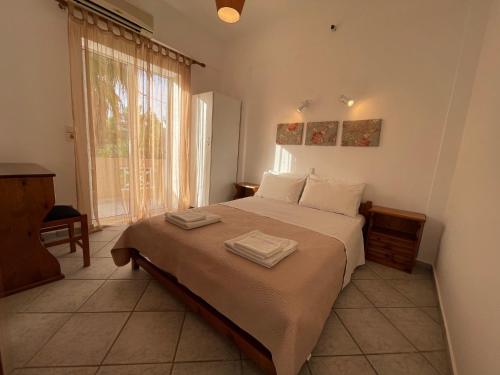 a bedroom with a bed with two towels on it at Nostalgia Villas in Tersanas