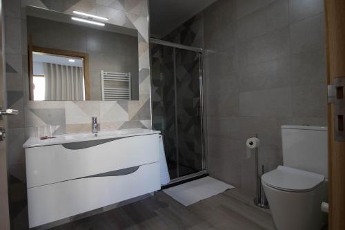a bathroom with a sink and a toilet at Vila Douro Guesthouse in Mesão Frio