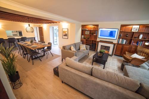 a living room with a couch and a dining room at Timber Hill - Parkfields in Haverfordwest