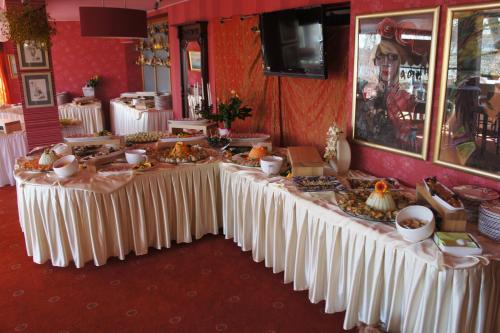 a long table with food on it in a room at To Tu in Mrągowo
