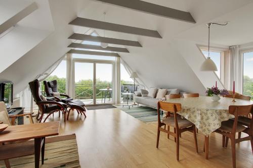 a living room with a table and chairs at Klitgaarden in Hjørring