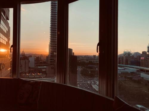 a view of a city skyline from a window at MU House in Taipei
