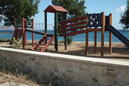 a playground with a slide next to the water at Gramvoussa Bay in Kissamos