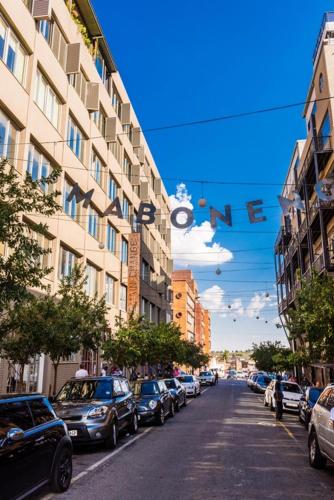 a street with cars parked on the side of a building at Maboneng City Building Free WiFi and Swimming pool in Johannesburg