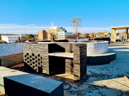 a stone bench sitting on top of a building at Maboneng City Building Free WiFi and Swimming pool in Johannesburg