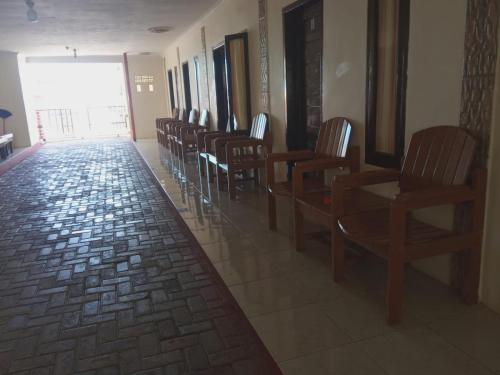 a row of chairs in a waiting room at penginapan karanglaut santolo in Cilauteureun