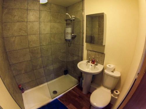 a small bathroom with a toilet and a sink at Cheltenham Studio Apartment in Cheltenham