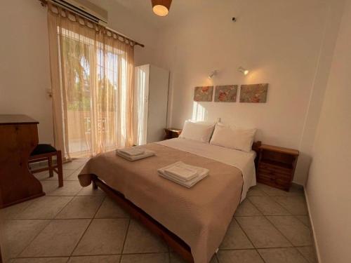 a bedroom with a bed with two towels on it at Nostalgia Villas in Tersanas