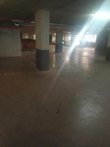 an empty parking lot with lights in a parking garage at Maboneng City Building Free WiFi and Swimming pool in Johannesburg