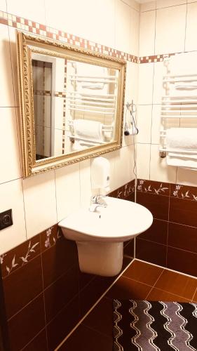 a bathroom with a sink and a mirror at Hotel Style BESSARABIA in Kiliya