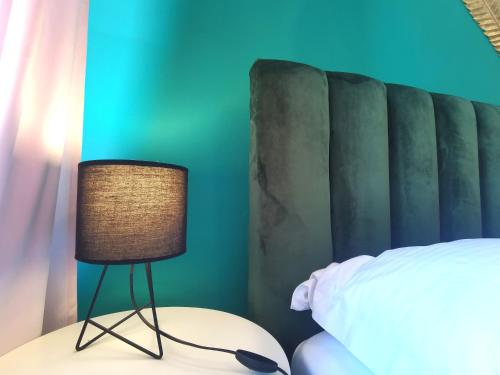a bedroom with a bed and a lamp on a table at Apartment HUM-the smallest town in the world in Hum