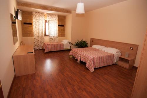 Voodi või voodid majutusasutuse Albergo Conca D'Oro toas