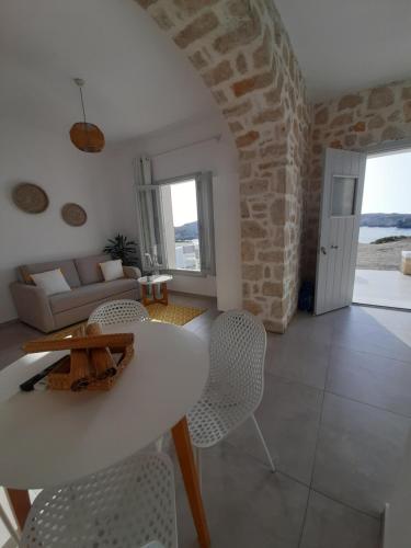 a living room with a white table and chairs at en lefko in Lefkos Karpathou