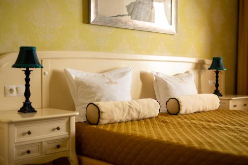a bedroom with a bed with two pillows on it at SleepWalker Boutique Suites in Wrocław