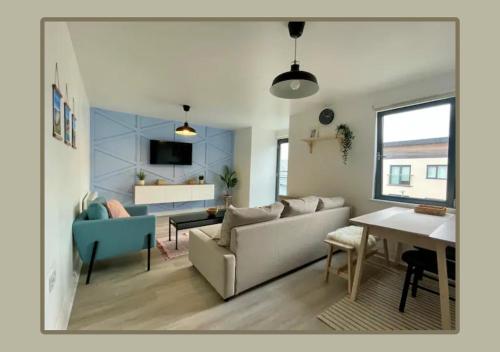 a living room with a couch and a table at Family Friendly Maritime Apartment in Swansea
