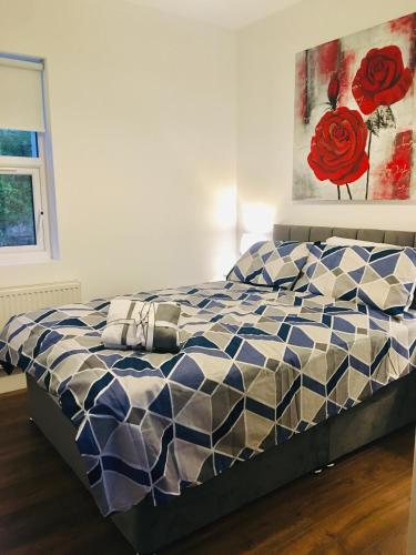 a bedroom with a bed with a blue at Keanes Country Cottage in The Heart Of The West in Lisacul