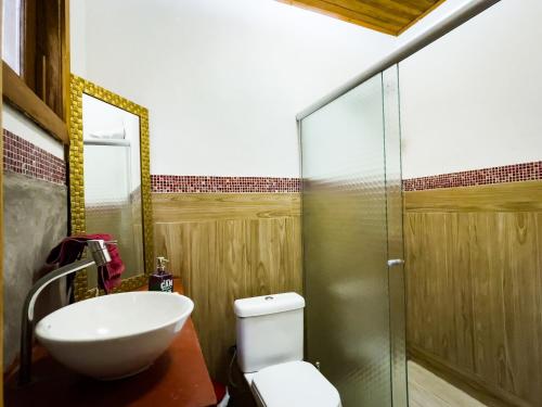 a bathroom with a sink and a toilet and a shower at Casa Refúgio Cantareira in Mairiporã