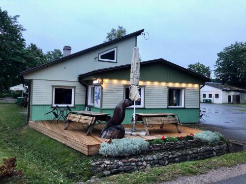 a house with a statue of a bear and an umbrella at Apartment Viiger in Kärdla
