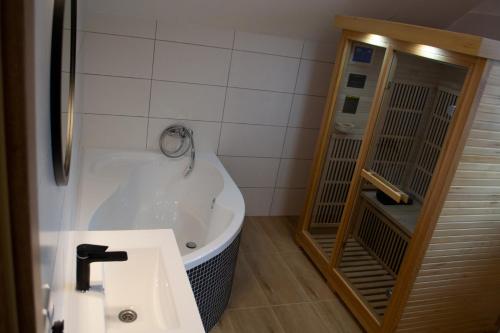 a bathroom with a tub and a sink at Chata u Potůčku in Trojanovice