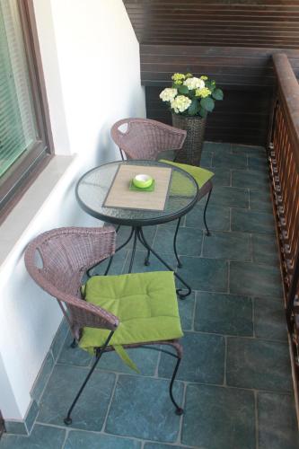 a patio with a table and chairs on a patio at Apartments Skok in Bled