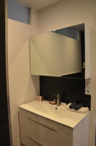 a bathroom with a sink and a mirror at LASUITE Domaine Bertuli, heated Pool, Aircon in Oppède