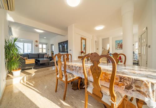 a dining room with a table and chairs at Dene Hollow Oroklini in Voroklini