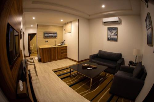 a living room with a couch and a table at جولدن نيو-Golden New in Jazan