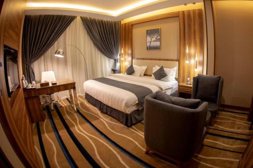 a hotel room with a bed and a chair at جولدن نيو-Golden New in Jazan
