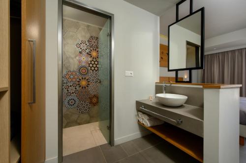 a bathroom with a sink and a shower at Olympion Village in Kavos